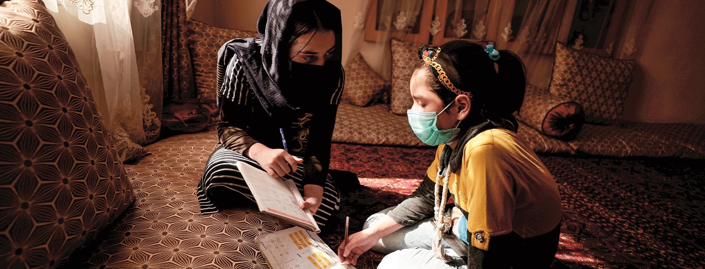 Photo of two female Afghan students studying