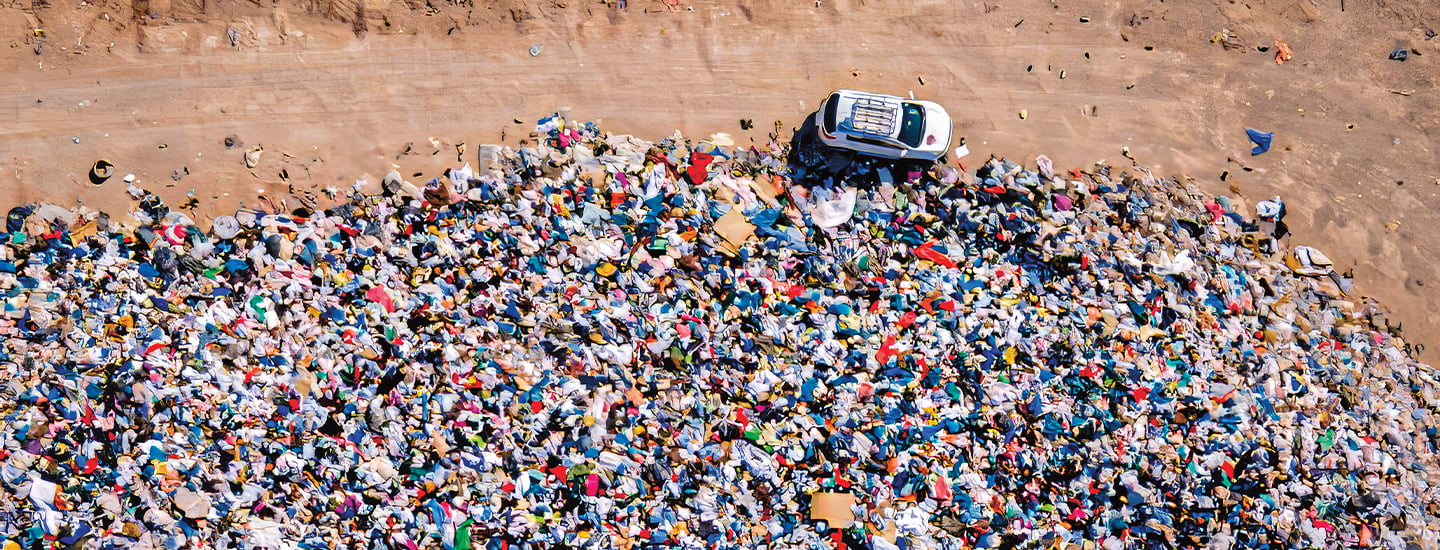 Bird&apos;s eye photo of a huge dump filled with thrown away clothes