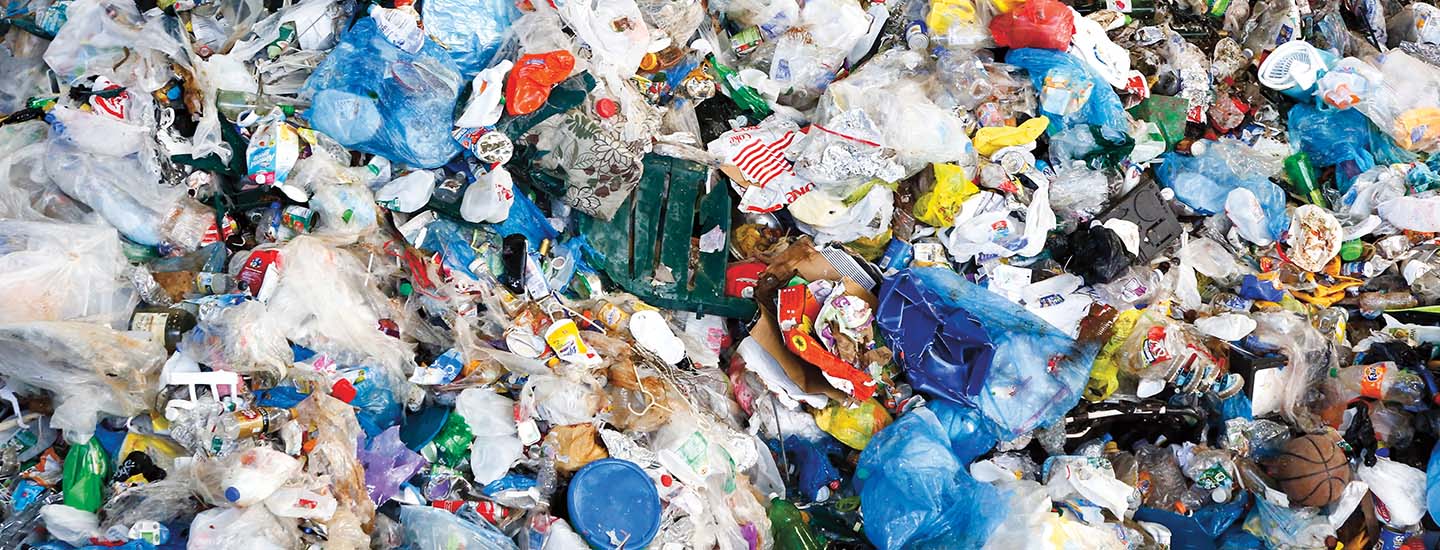A large pile of mixed plastic waste including bottles, bags, and containers in various colors